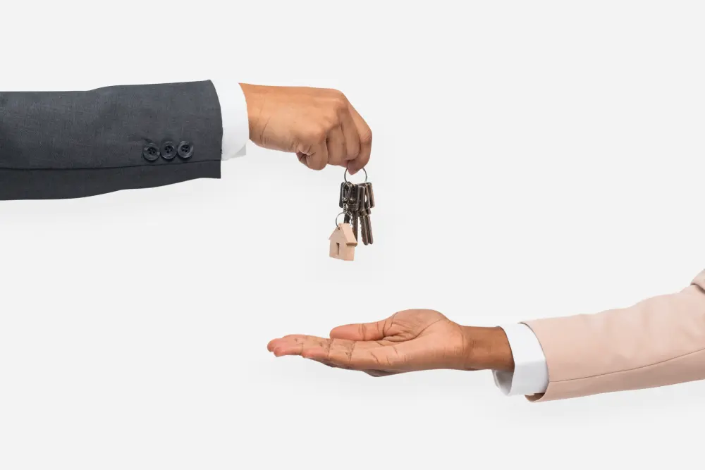 hand giving key real estate agent