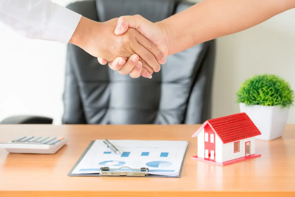 agent client shaking hands after signed contract buy new apartment